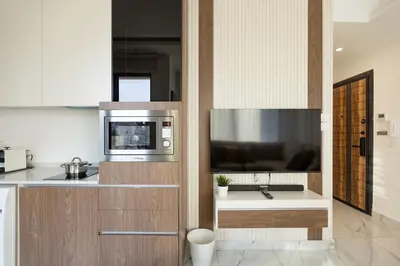 a kitchen with a microwave and a television on a counter at Shamsi Apartments 329 in Amman