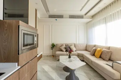 a living room with a couch and a tv at Shamsi Apartments 329 in Amman