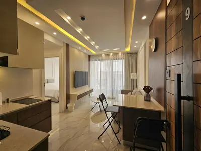 a living room with a kitchen and a bedroom at Shamsi Apartments 009 in Amman