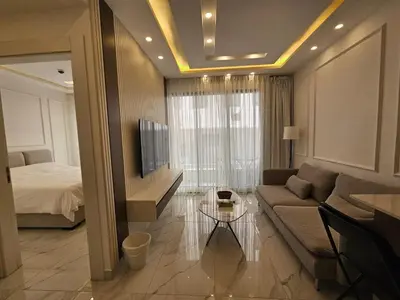 a living room with a couch and a bed at Shamsi Apartments 009 in Amman