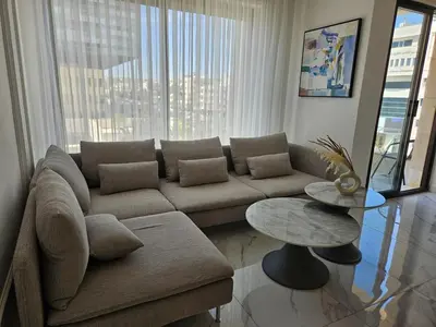 a living room with a couch and a table at Shamsi Apartments 436 in Amman