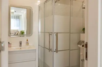 a bathroom with a shower and a sink at Shamsi Apartments 436 in Amman