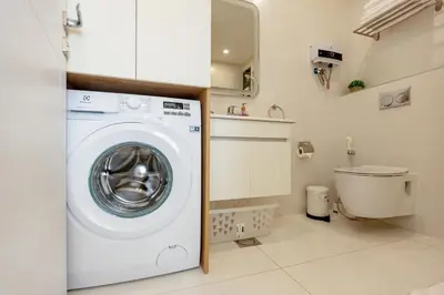 a small laundry room with a washing machine at Shamsi Apartments 437 in Amman