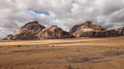 a group of rocky mountains in the desert at Crown Luxury Camp in Wadi Rum