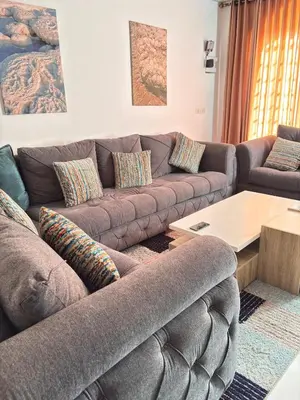 a living room with a couch and a table at DeadSea studio in Sowayma
