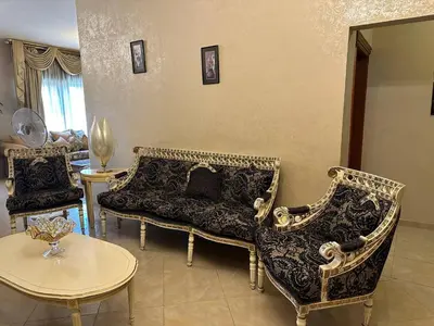 a living room with two couches and a table at شقة مفروشة في حي نزال Furnished Apartment Hay Nazzal in Amman