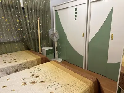 a room with two beds and a fan at شقة مفروشة في حي نزال Furnished Apartment Hay Nazzal in Amman