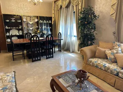 a living room with a couch and a table at شقة مفروشة في حي نزال Furnished Apartment Hay Nazzal in Amman