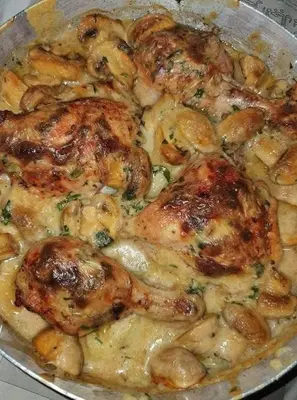a pan of food with chicken and mushrooms in it at kazbon House in Al Hāshimīyah