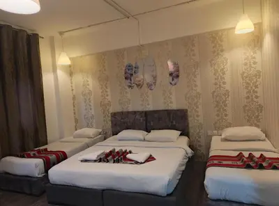 a bedroom with two beds with red bows on them at Gate Inn in Amman
