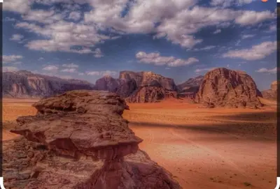 a view of the desert with mountains in the background at Al-Faris Camp in Disah