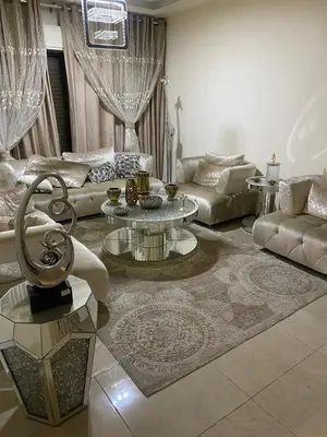 a living room with a couch and a table at Amman Apartment 123 in Amman
