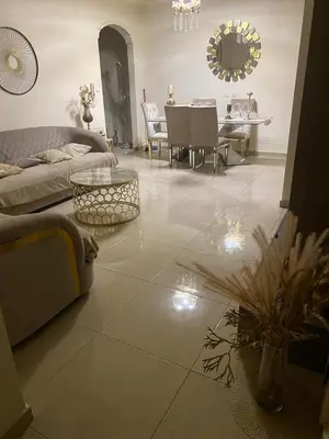 a living room with a couch and a table at Amman Apartment 123 in Amman