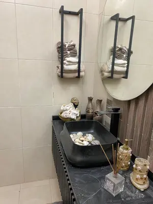 a bathroom with a bath tub and a mirror at Amman Apartment 123 in Amman