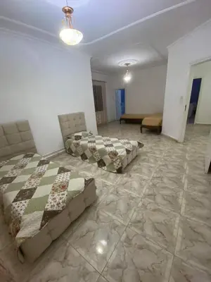 a room with two beds and a couch in it at 909 apartment in Amman