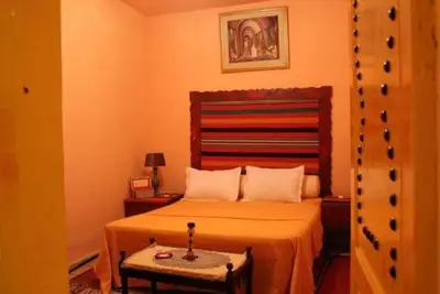 a bedroom with a bed and a table in it at asfouer Hostel in Muqbilah