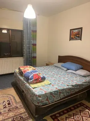 a bedroom with a large bed in a room at University Castle in Amman