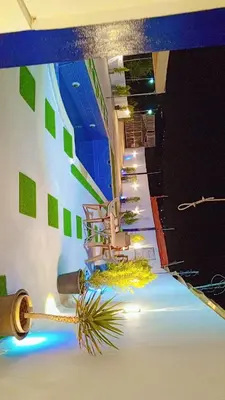 a room with a staircase with green squares on the wall at Sky Blue Farm in Umm Jawzah