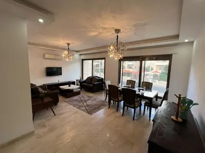a living room with a table and chairs and a couch at On the street 3 Room in Amman