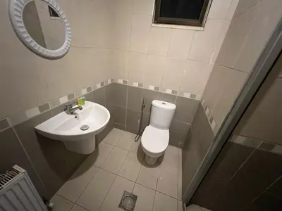 a small bathroom with a toilet and a sink at On the street 3 Room in Amman
