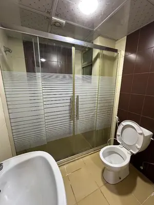 a bathroom with a shower and a toilet and a sink at gardens studio استوديو الجاردنز 401 in Amman