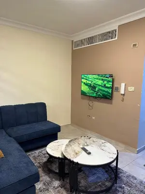 a living room with a couch and a table at gardens studio استوديو الجاردنز 401 in Amman