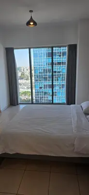 a large bed in a room with a large window at One Bedroom Damac Tower 8th Floor Boulevard Abdali غرفة وصالة فاخرة - برج داماك العبدلي البوليفارد الطابق الثامن in Amman