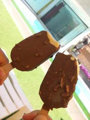 a person holding two pieces of chocolate covered food at Firuza Farm Villa Vip in Al Rama