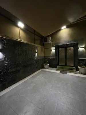 an empty room with a fireplace and a stone floor at Firuza Farm Villa Vip in Al Rama