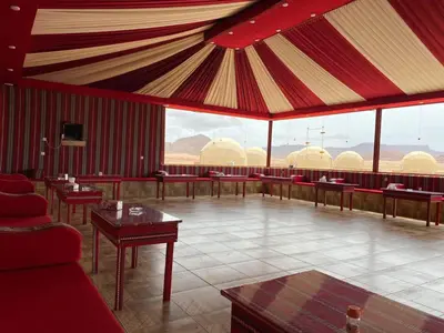 a large room with tables and chairs and a tent at جمال رم in Aqaba