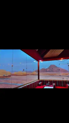 a view of the desert from a room with windows at جمال رم in Aqaba