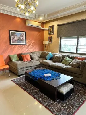a living room with a couch and a coffee table at shafa badran شفا بدران ام الحجير in Amman