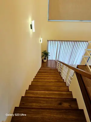 a staircase in a house with a potted plant at C33 Samarah Resort LOFT apartment in Sowayma