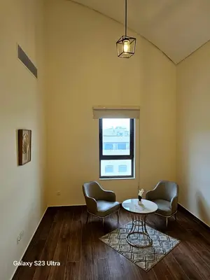 a room with two chairs and a table and a window at C33 Samarah Resort LOFT apartment in Sowayma