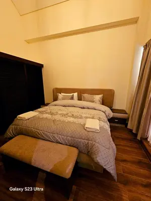 a bedroom with a large bed in a room at C32 Samarah Resort LOFT apartment in Sowayma