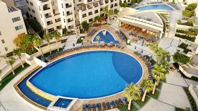 an overhead view of a large swimming pool in a city at C04 Samarah Resort One Bedroom apartment in Sowayma
