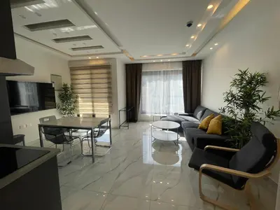 a living room with a couch and a table at Premium 1BR Furnished Apartment in Amman