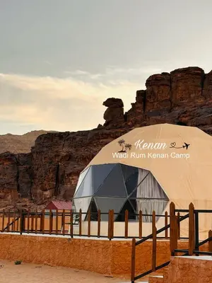 a yurt in the desert near a fence at Wadi Rum Kenan Camp in Wadi Rum