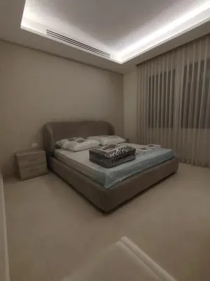 a bedroom with a bed in a room at Newly Built apartment Deir Ghbar in Amman
