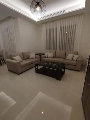 a living room with two couches and a coffee table at Newly Built apartment Deir Ghbar in Amman