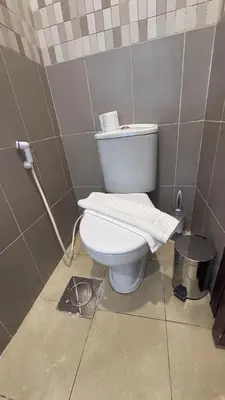 a bathroom with a white toilet in a stall at يزن للاجنحة الفندقية in Aqaba