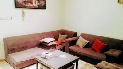 a living room with a couch and a table at VOV House in At-Tafilah