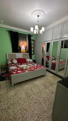a bedroom with a bed in a room with mirrors at VOV House in At-Tafilah