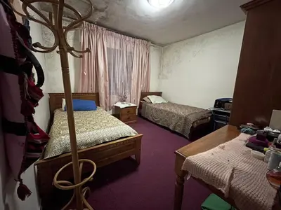 a room with two beds and a pole in it at zainab house in Amman
