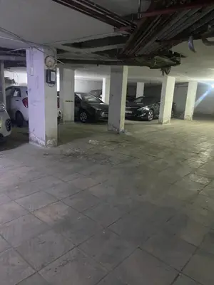 an empty parking garage with cars parked in it at zainab house in Amman