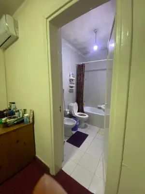 a bathroom with a toilet and a sink and a tub at zainab house in Amman