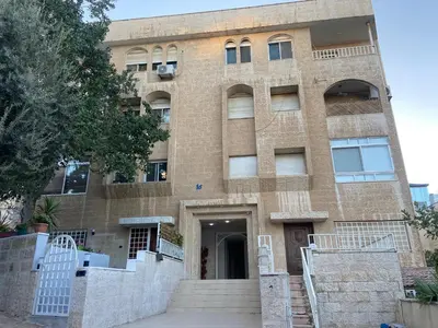 a large brick building with stairs in front of it at zainab house in Amman