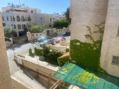 a view of a parking lot from a building at zainab house in Amman