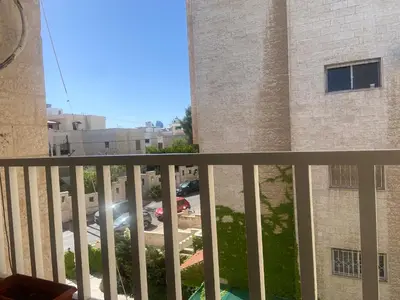 a balcony with a view of a parking lot at zainab house in Amman