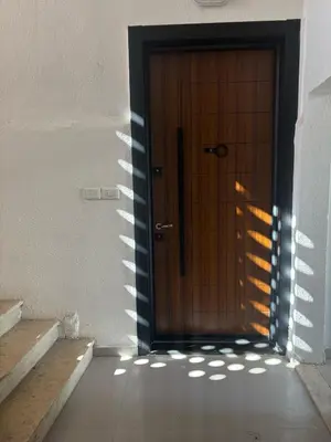 a wooden door in a room with stairs at Modern 2BR in Trendy Jabal AlWebdeh with View in Amman